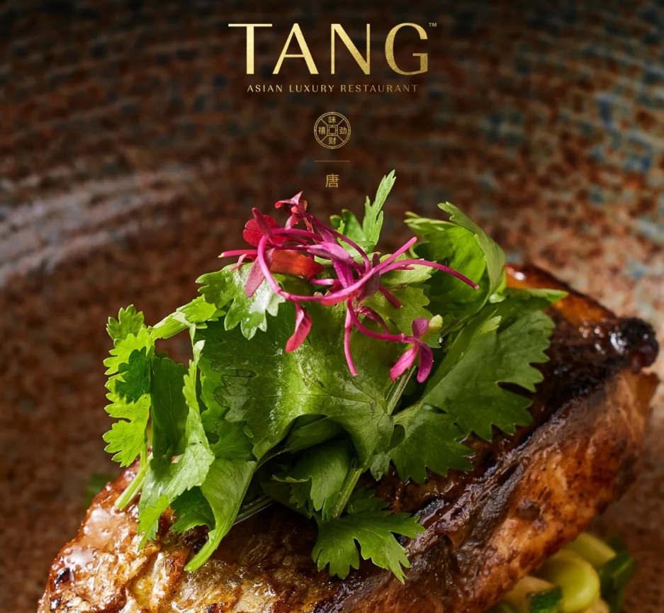 TANG seared fish topped with cilantro and purple microgreens
