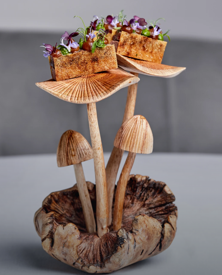 Sculptural mushrooms serving gourmet canapés with microgreens