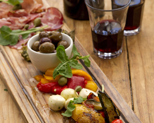 Café Paradiso antipasti board with olives, mozzarella and red wine