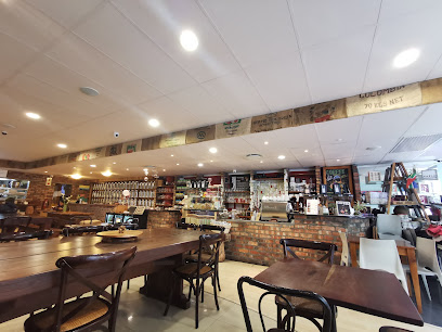 Nigiro Teacafe interior with wooden tables, tea jars on shelves and service counter