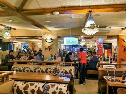 Little Creek Spur dining room with cow-print booths and seated diners