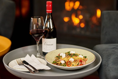 Camps Bay Social Club pasta with red wine on tray by fireplace
