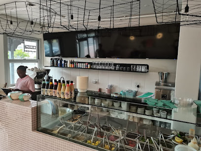 The Poke Co. Somerset West counter with glass ingredient display and sauce bottles