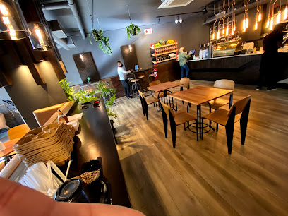 Shift Espresso Bar Glengariff interior with barista at counter and wooden tables