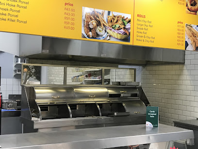 Tony's Fisheries stainless-steel hot counter under yellow fish-and-chips menu