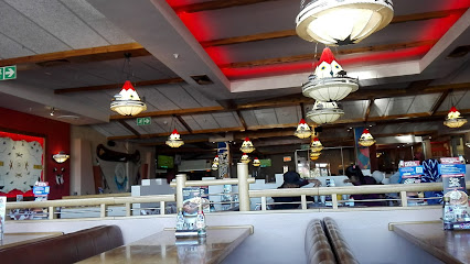 Twin Peak Spur Halaal family dining room with booths and hanging lamps