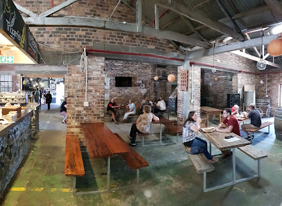 Triggerfish Brewing taproom with guests at communal wooden tables