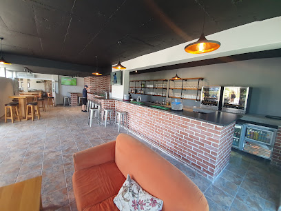 Strand Golf Club Restaurant interior with long brick bar and seating