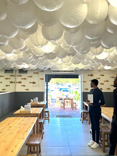 Sushi Box Somerset West dining area with white paper lantern ceiling and wooden tables