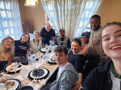Guests enjoying a catered African meal by Inyameko Catering at a family-style dining table