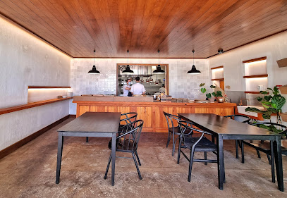 Geuwels dining area with wooden counter and open kitchen