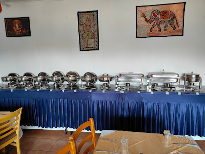 Indian Express Parkland buffet line with stainless chafing dishes and blue skirt