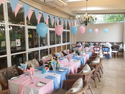 Coffee Time interior with pastel pink and blue table settings and balloons