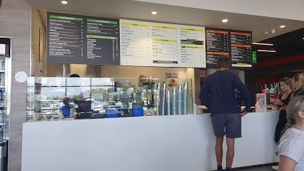KAUAI Virgin Active Table Bay counter with overhead menu boards and customers ordering