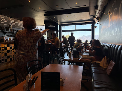 Bootlegger Blouberg interior with diners and ocean view through window