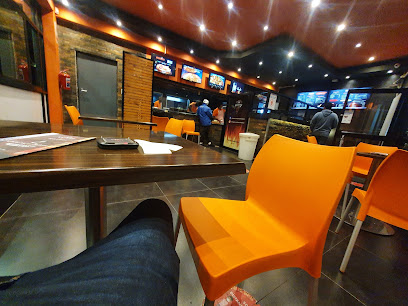 Bin Rashied Woodstock dining interior with orange chairs and counter menus