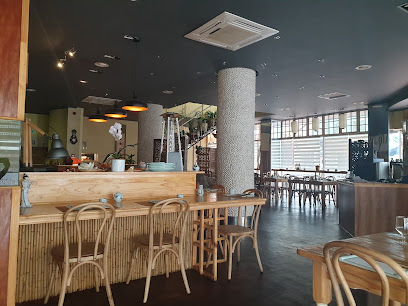Tomo Japanese Restaurant interior with wooden bar, rattan chairs and dining tables