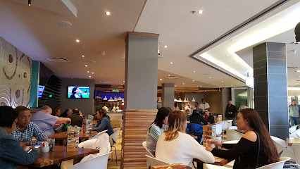 Cafe Rousse interior with diners at tables, warm modern bistro setting
