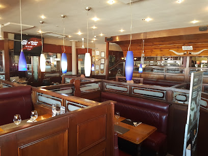 Cattle Baron Blouberg interior with leather booths and pendant lights