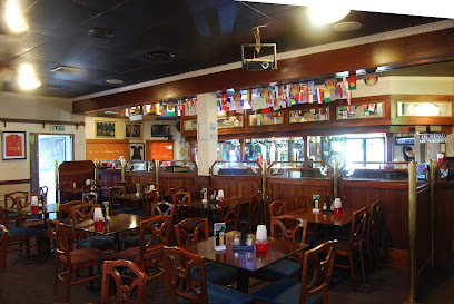 Old Bridge Restaurant & Bar interior with wooden tables, chairs and bar
