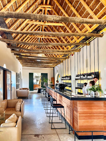 Clara's Barn rustic dining room with long wooden bar and staff
