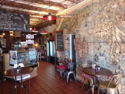Interior of The Lighthouse Cafe with vintage map mural, round tables and counter