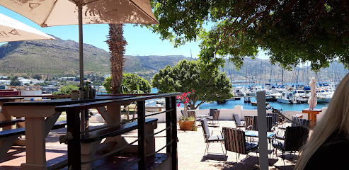 False Bay Yacht Club outdoor dining terrace overlooking harbor and moored yachts