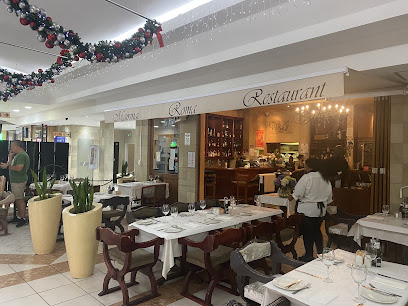 Mamma Roma Newlands dining area with white-tablecloth tables and visible bar
