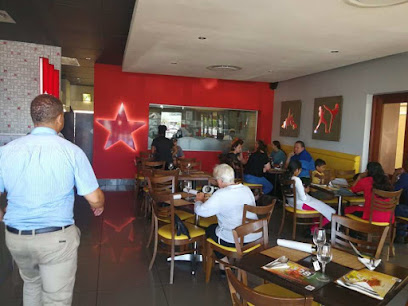 Simply Asia Glengarry dining room with customers at wooden tables and illuminated red star wall