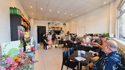 Pho House Halal Vietnamese dining area with customers at tables and counter