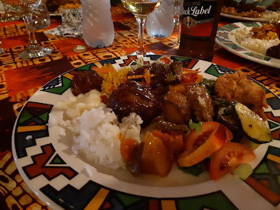 Lelapa Restaurant dinner plate with rice, stewed meat, and roasted vegetables
