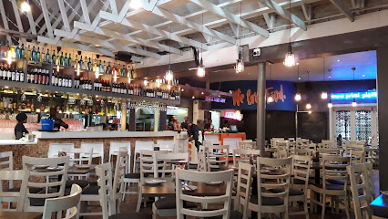 PRIMI Constantia dining area with bar and stocked wine shelves