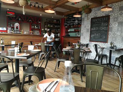 Caramba Authentic Portuguese Restaurant interior with server setting table