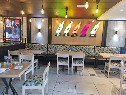 Barcelos Observatory St Peter's Square dining area with colorful chicken signs