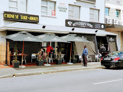 The Butcher's Wife restaurant front with outdoor seating and umbrellas