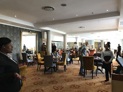 The Peach Tree Restaurant dining room with staff serving seated diners