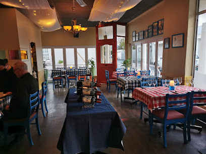 Al's Place Restaurant interior with checkered tablecloths, blue chairs, wine.
