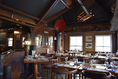 Mariner's Wharf Harbour Front Emporium dining room with set wooden tables