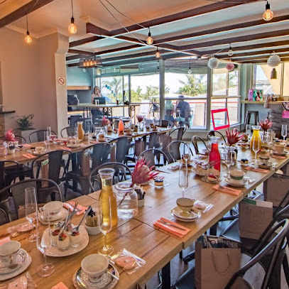 Neighbourhood Cafe Ramasibi dining room with long tables set for a meal