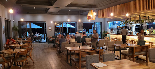 Sunbird Restaurant dining area with seated guests and bar