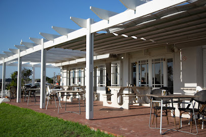 Ou Meul Melkbosstrand café outdoor shaded patio with tables and chairs