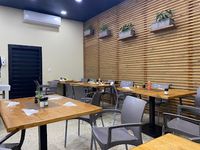 The Sushiary dining area for halal sushi with wooden tables and chairs