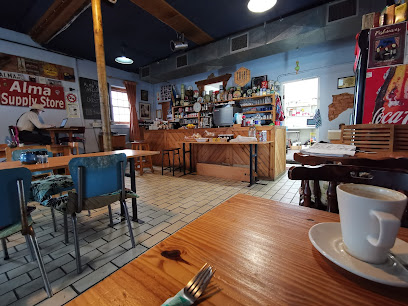 The Alma Cafe interior: wooden tables, service counter, coffee cup