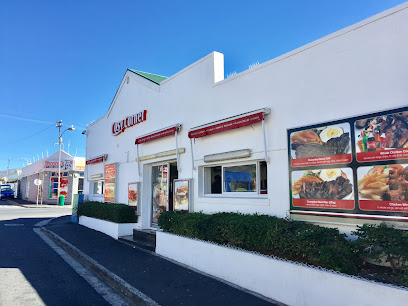 Cosy Corner restaurant exterior with menu photos and red awnings