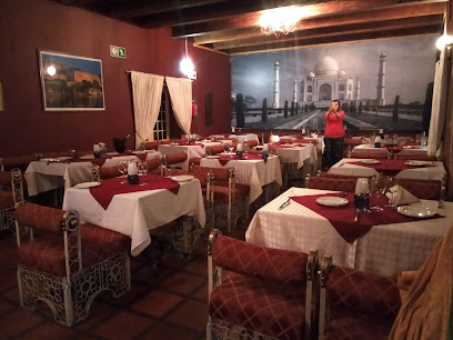 Moksh Indian Restaurant Somerset West dining room with set tables and Taj Mahal mural