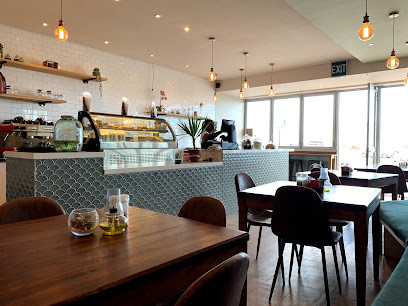 Salt & Sage Rondebosch cafe interior with service counter, display case and dining tables