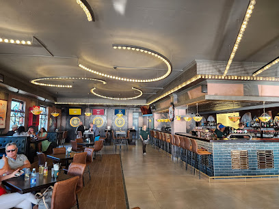 Happy Folks Big Bay dining room with bar, booths, and circular ceiling lights