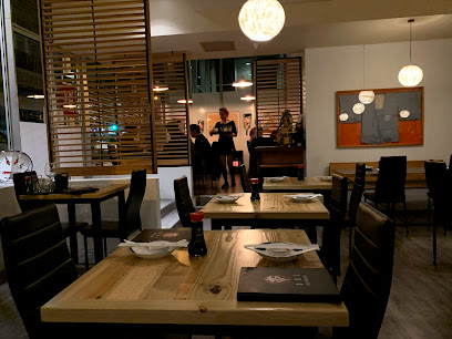 Obi Restaurant dining room with wooden tables, place settings and servers
