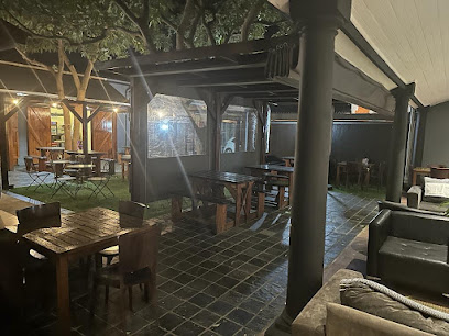 The Bacon Spot outdoor dining area with wooden tables and covered seating