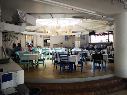 Mykonos Restaurant Cavendish dining room with blue chairs and white tablecloths